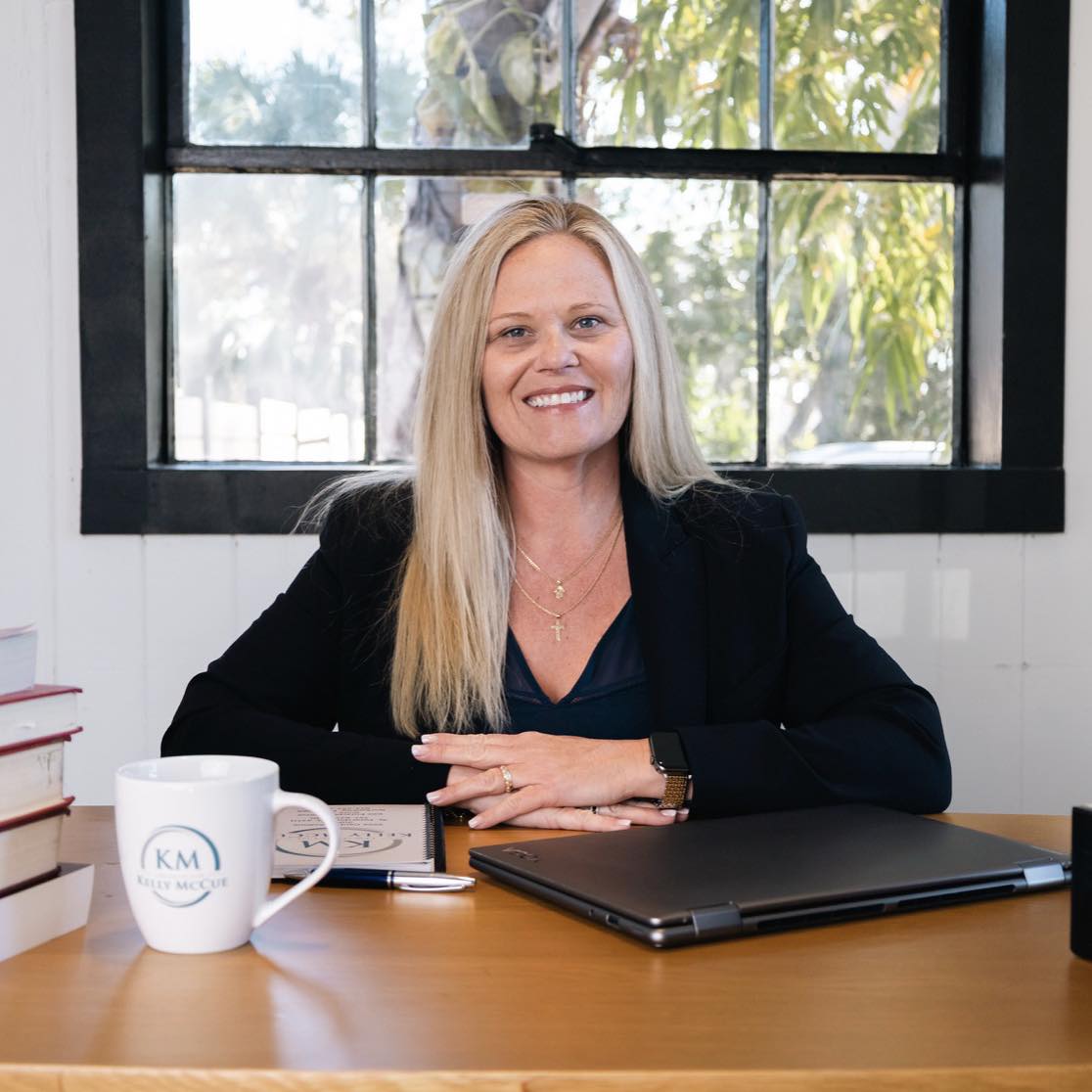 Kelly McCue at her desk providing personal attention for injury clients in St. Petersburg